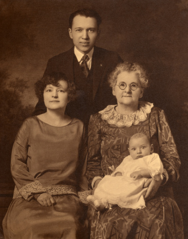Vintage sepia image of three generation family, circa 1926.