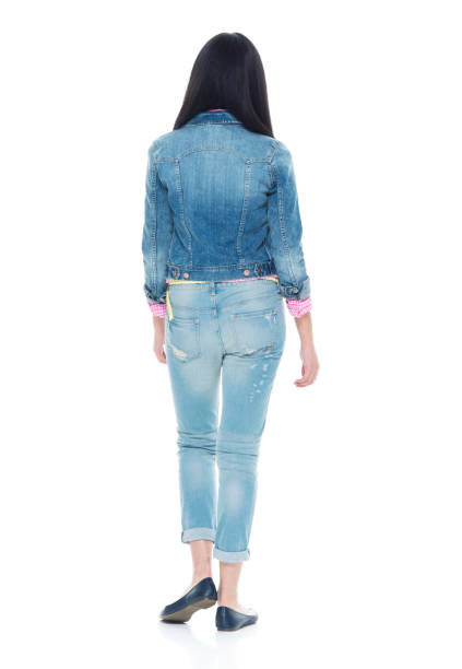 istock Pretty lady in double denim with hands by side 932853422