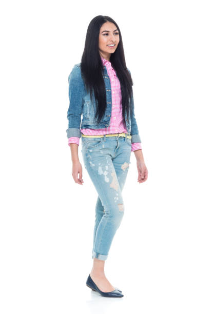 istock Pretty lady in double denim with hands by side 932855530