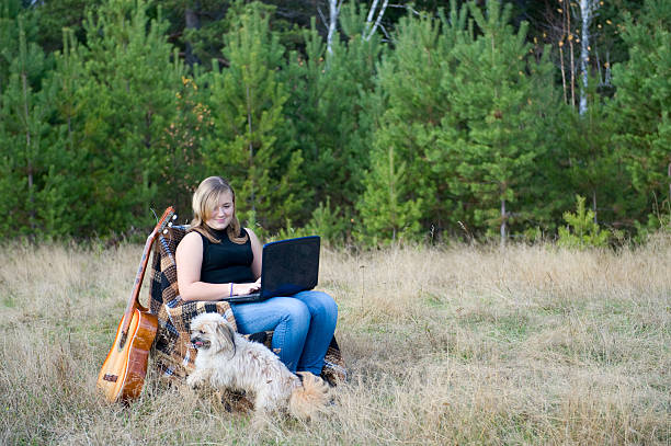 istock girl on the nature with  laptop. 93286732