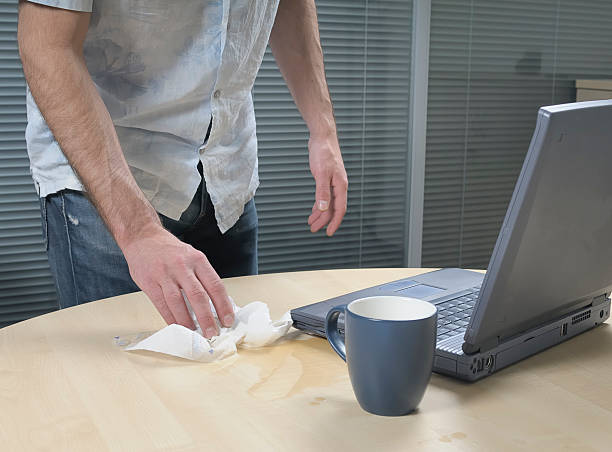 istock Cleaning Up Spillage Next To A Laptop 93287134