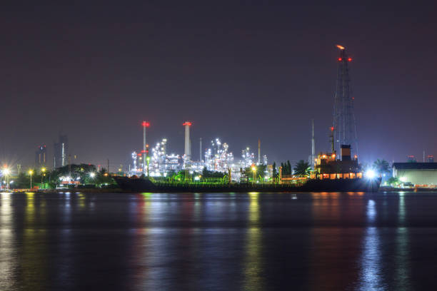 istock Oil refinery at the river in night time 932891588