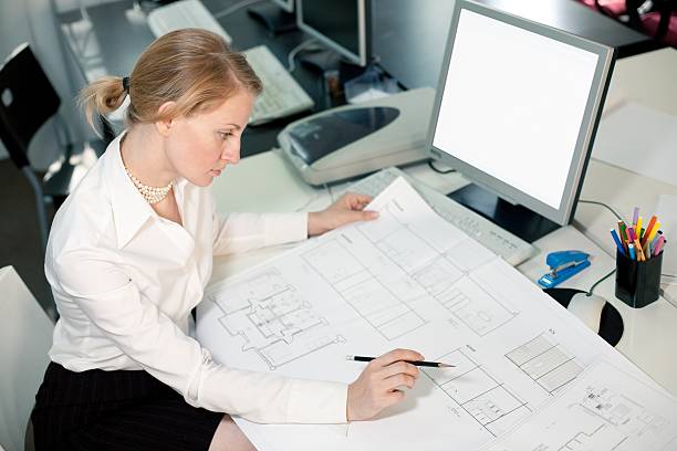 istock High angle view of a businesswoman working on blueprints 93289409