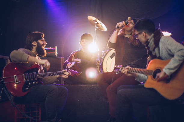 istock Young rock band playing in club 932914538