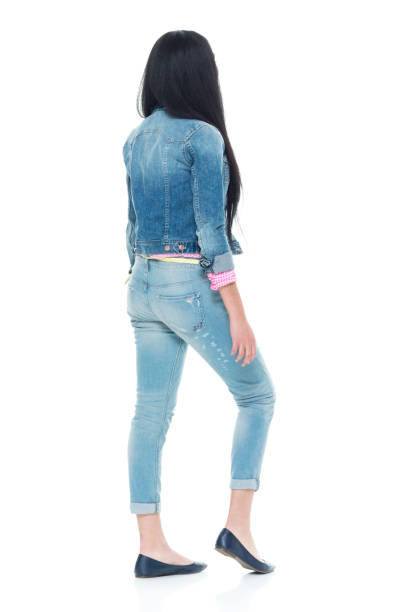 istock Pretty lady in double denim with hands by side 932931186
