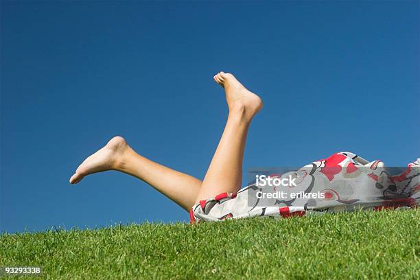 Legs Of A Woman Laying On Green Grass Stock Photo - Download Image Now - Joy, Summer, Women