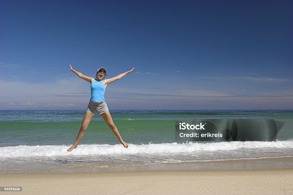 Jump to the sky Beautiful young woman jumping on a beautiful beach Active Lifestyle Stock Photo