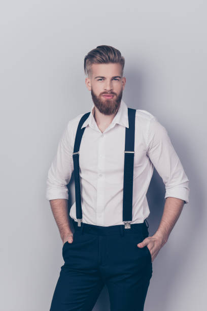 istock Vertical front view portrait of chic posh stylish confident focused concentrated stunning rich wealthy macho with blonde hair keeping hands in pockets sexy look isolated on gray background 932956024