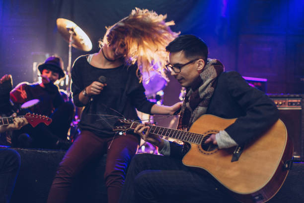 istock Rock band performing at a nightclub 932956502