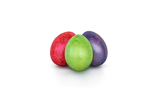 Three colorful handmade easter eggs isolated on a white. Red, green, purple egg painted with shiny paint. Decorative elements for Easter celebration