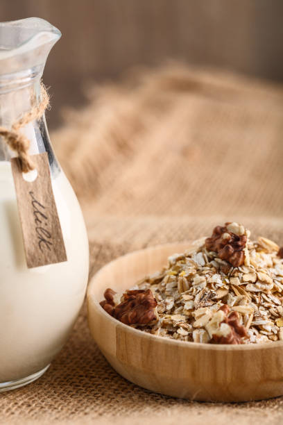 istock Dry rolled oatmeal in wooden bowl on textile background 932957096