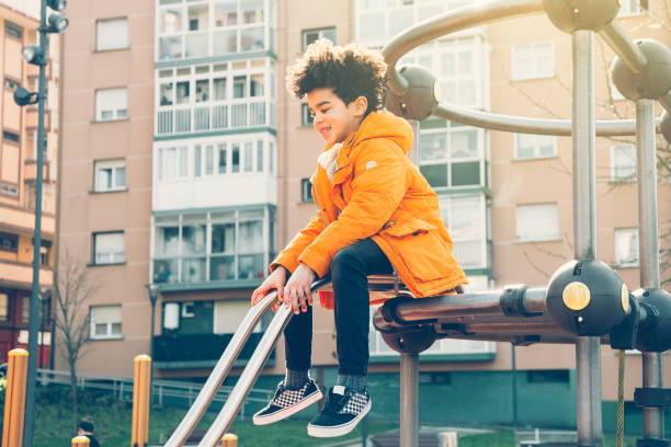 istock Happy little boy having fun in an urban playground 932957240