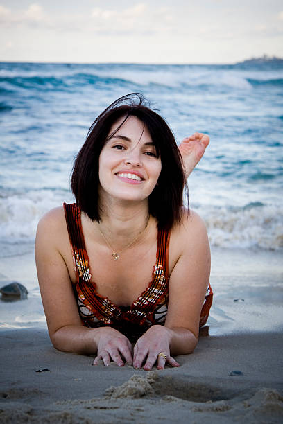 istock Beautiful young woman smiling on a beach 93295808