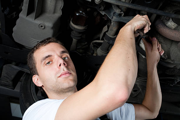 istock Young Mechanic working below car with wrench 93297154