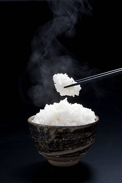 istock Bowl of steaming hot rice with chopsticks 93298601