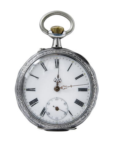 two minutes to twelve o'clock on old pocket watch on silver fabric background