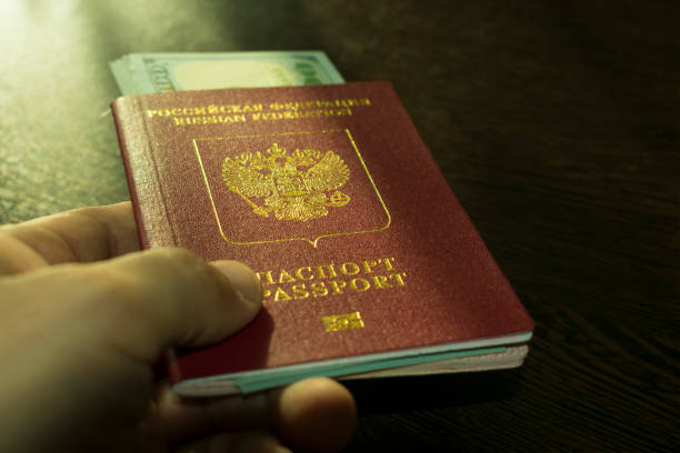 istock passport with money in hand 933003824