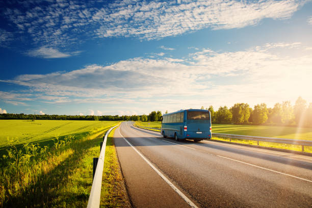 Bus on asphalt road in beautiful spring day stock photo