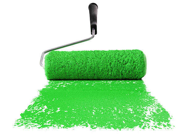 Paint roller With green paint isolated over white background