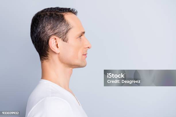 Profile Half Face Portrait With Copy Space Of Trendy Attractive Stylish Man Looking At Empty Place For Advertisement Product Having Perfect Ideal Oiled Dry Skin Isolated On Grey Background Stock Photo - Download Image Now