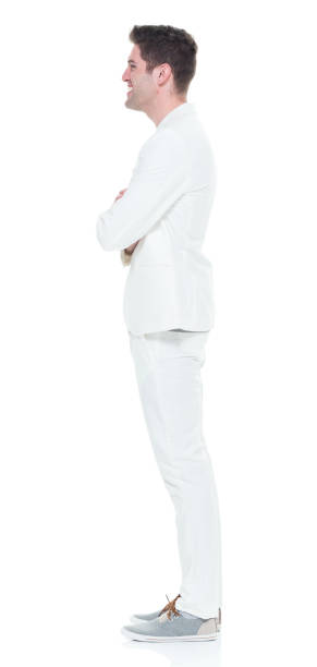 istock Handsome man in white suit with arms crossed 933080856