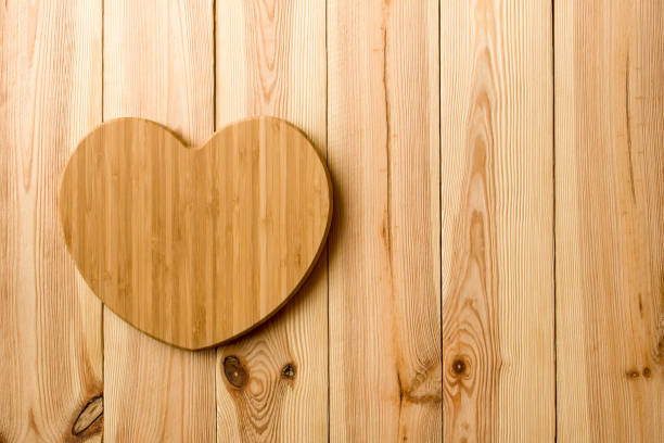istock Bamboo heart-shaped cutting board on a wooden table background 933090662