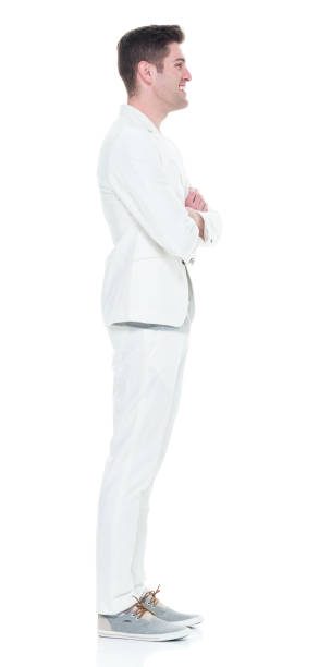 istock Handsome man in white suit with arms crossed 933090840