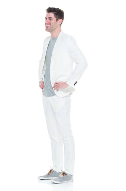 istock Handsome man in white suit with hands on hips 933093920