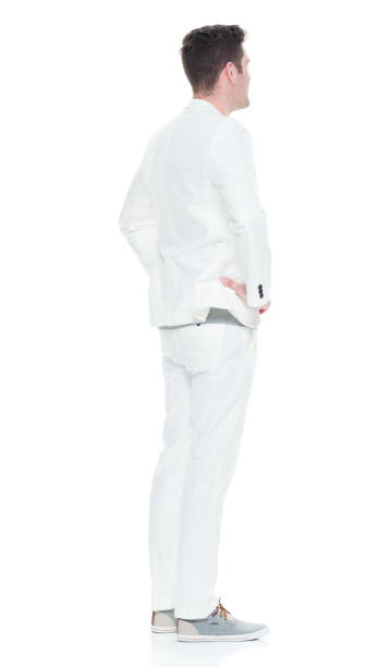 istock Handsome man in white suit with hands on hips 933094252