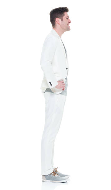 istock Handsome man in white suit with hands on hips 933094658