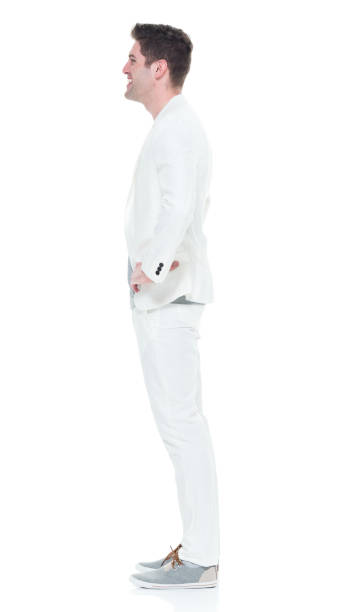 istock Handsome man in white suit with hands on hips 933097156