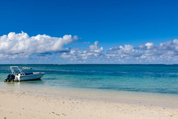resting motorboat on mauritius island coastline, indian ocean, africa.