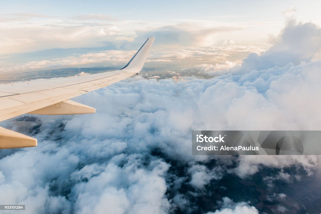 Airplane Wing in Flight from window, cloudy sky Airplane Wing in Flight from window, cloudy sky, London (GB) - Venice (Italy). Airplane Stock Photo