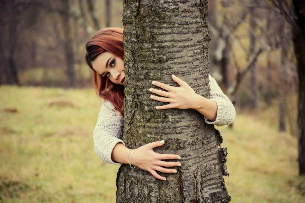 istock Attractive young woman near a tree 933104984