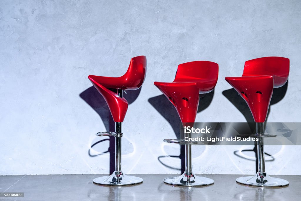 Three Empty Stools Three Red Empty Bar Stools Near Grey Wall Stock Photo - Download Image ...