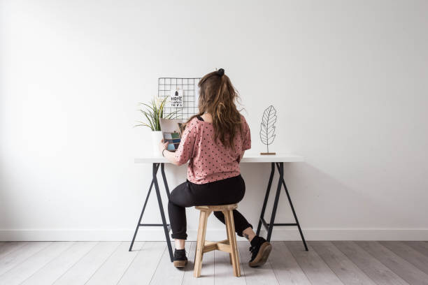 istock young woman reading a magazine in het white modern room 933109062