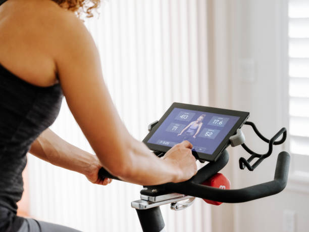 istock Woman Exercising on exercise bike in Home 933109216