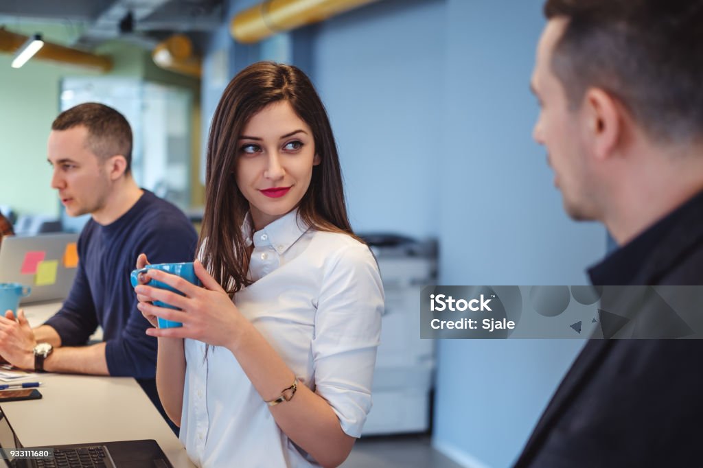 Girl looking at her colleague with love in her eyes Girl looking at her colleague with love in her eyes while he is talking Flirting Stock Photo