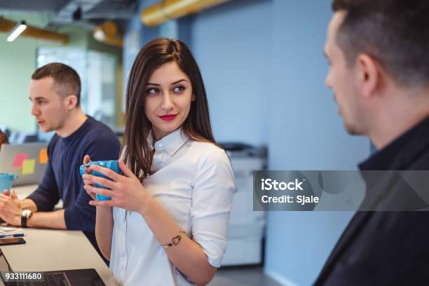 Girl Looking At Her Colleague With Love In Her Eyes Stock Photo - Download Image Now