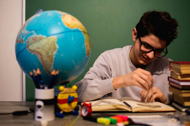 istock Education concept. Portrait of child with learning difficulties. Tired boy doing home assignment. 933112604