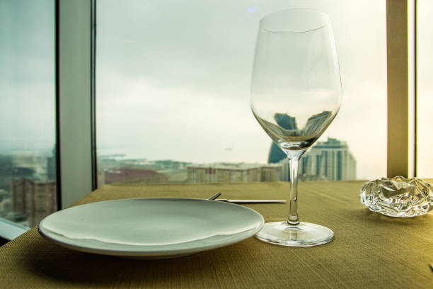 istock Empty wine glass on the table in front of a window 933115342