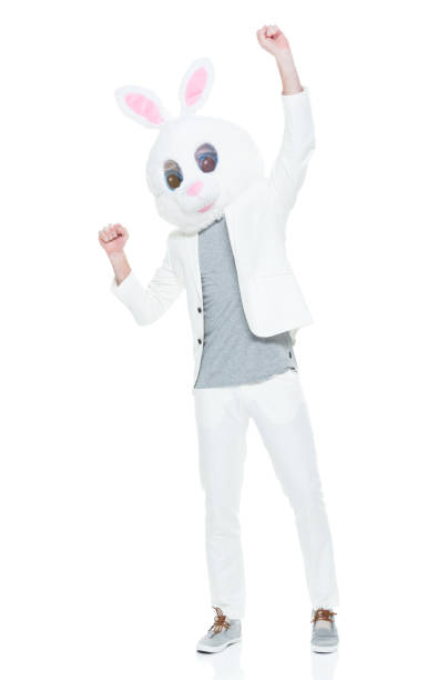 istock Well dressed man with bunny costume cheering 933115734