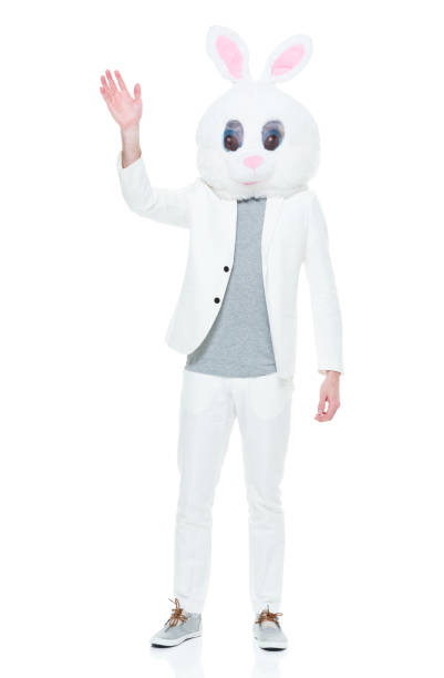 istock Well dressed man with bunny costume waving 933115742