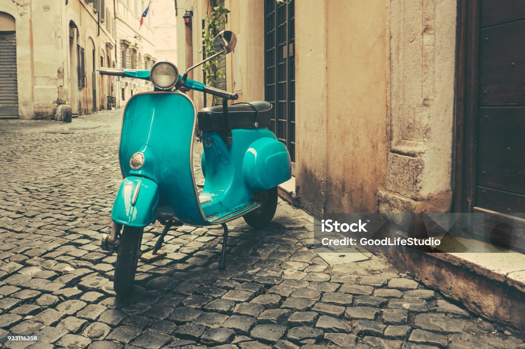 Vintage motor scooter on the street in Italy Vintage motor scooter on the rustic cobblestone street in Rome, Italy. Rome - Italy Stock Photo