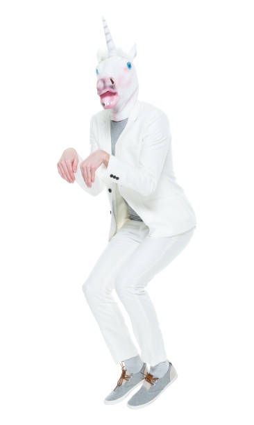 istock Man wearing unicorn mask dancing 933118188