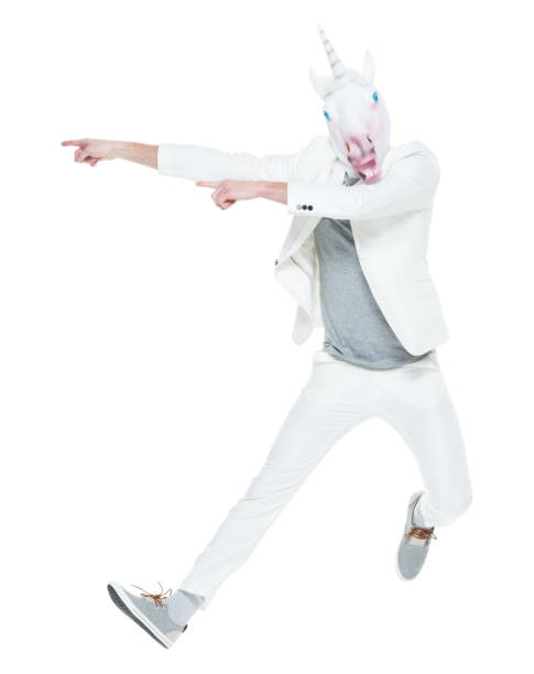 istock Man wearing unicorn mask jumping 933119162