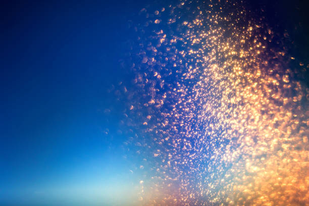 istock Glitter lights abstract background with gold particles. Defocused bokeh dark festive texture