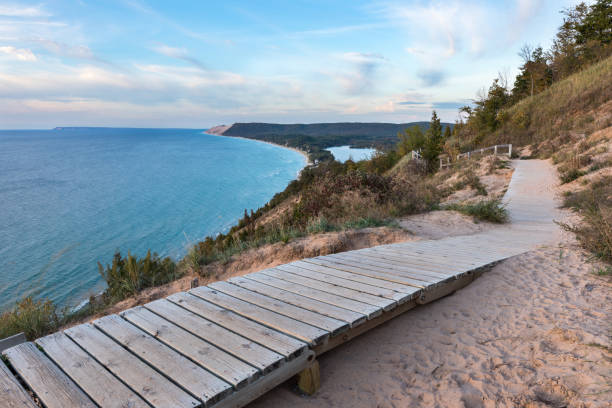 Lake Michigan Overlook at Sleeping Bear Dunes in Michigan A weathered wooden walkway on the Empire Bluffs Trail is the perfect overlook to see Lake Michigan, the Sleeping Bear Dunes, and the Manitou island sleeping bear dunes national lakeshore photos stock pictures, royalty-free photos & images
