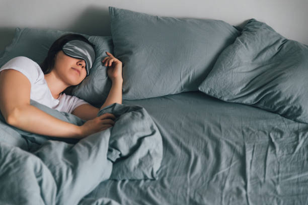 istock woman sleep in eye patch in grey bed. copy space 933132962