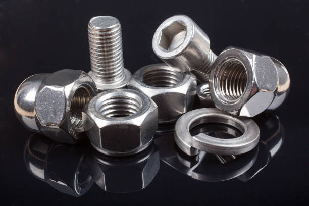 istock Bolts and nuts on black background. Industry or construction concept 933133800